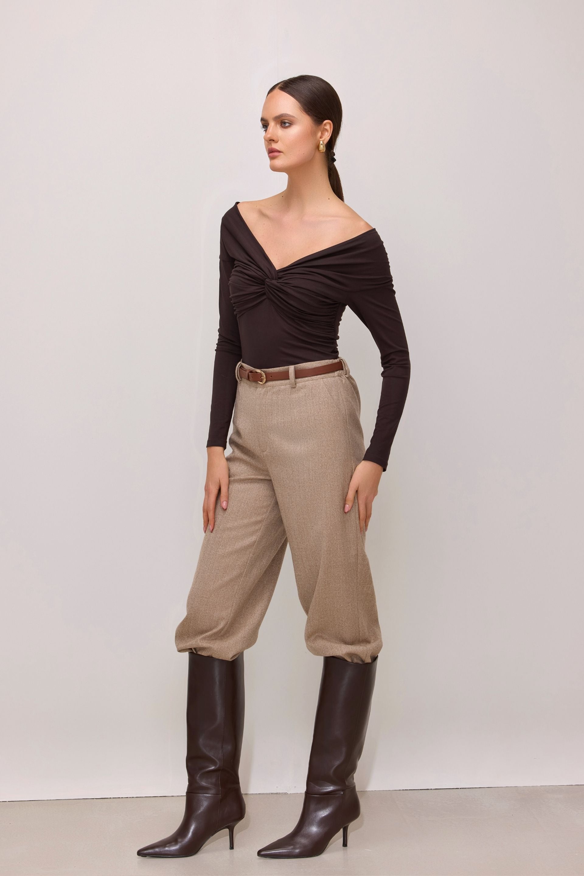 Brown off-the-shoulder blouse with long sleeves and a wrap