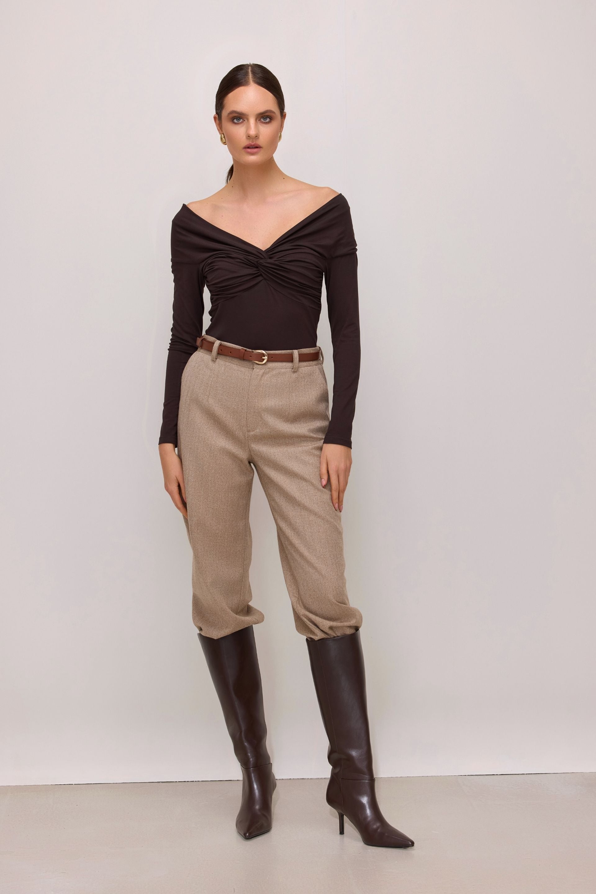 Brown off-the-shoulder blouse with long sleeves and a wrap