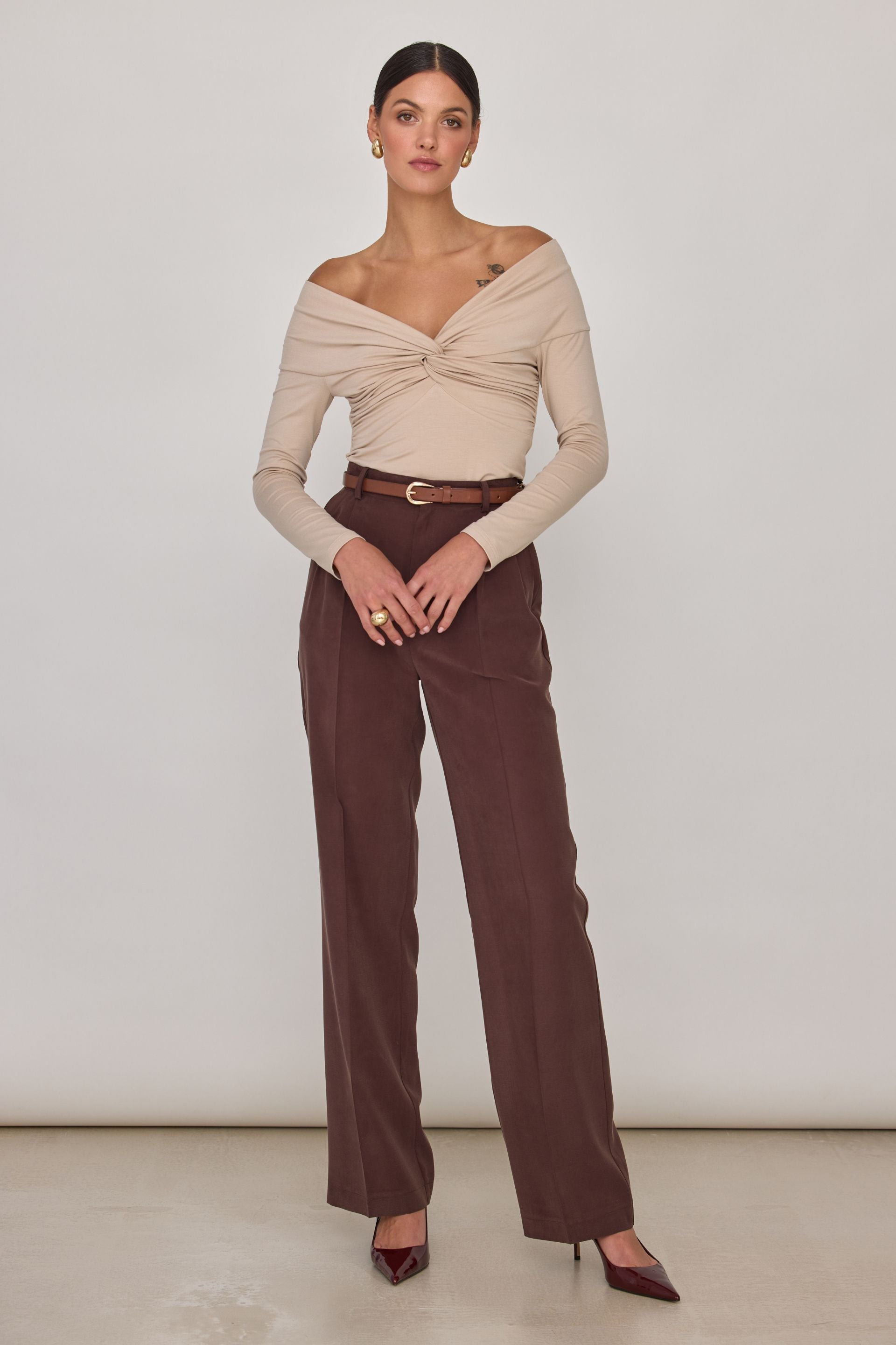 Brown off-the-shoulder blouse with long sleeves and a wrap