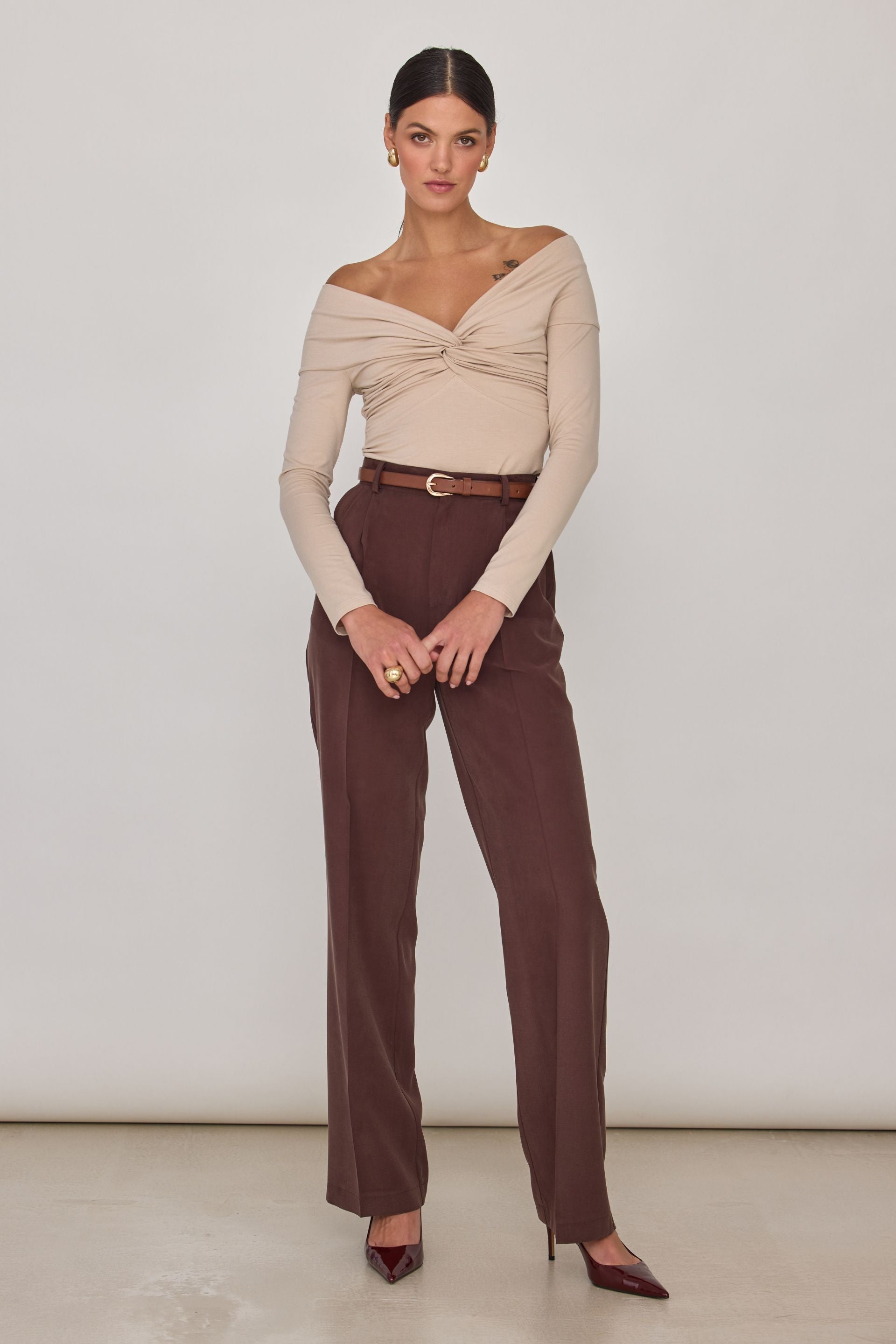Brown off-the-shoulder blouse with long sleeves and a wrap