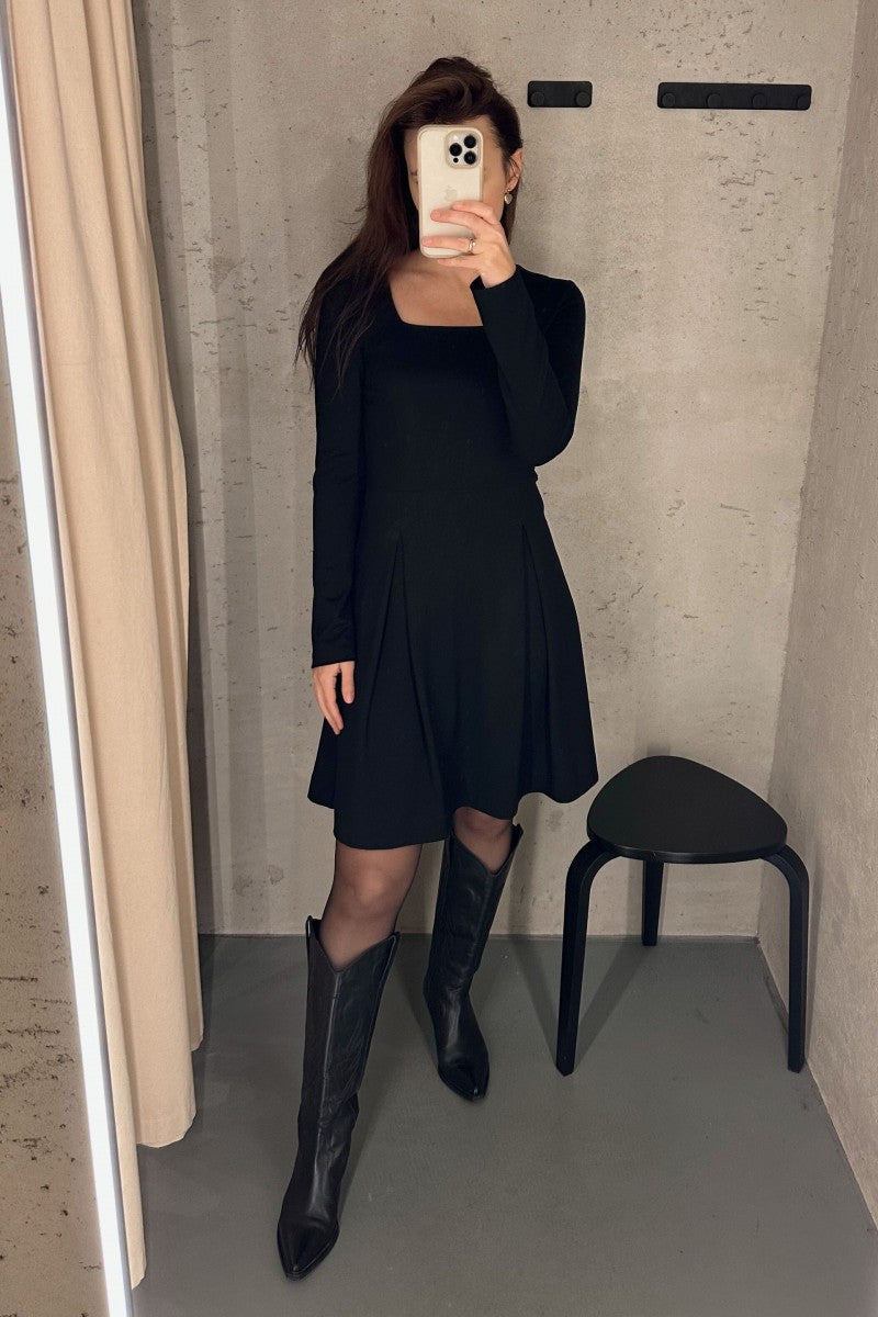 Black flared dress with a square neckline