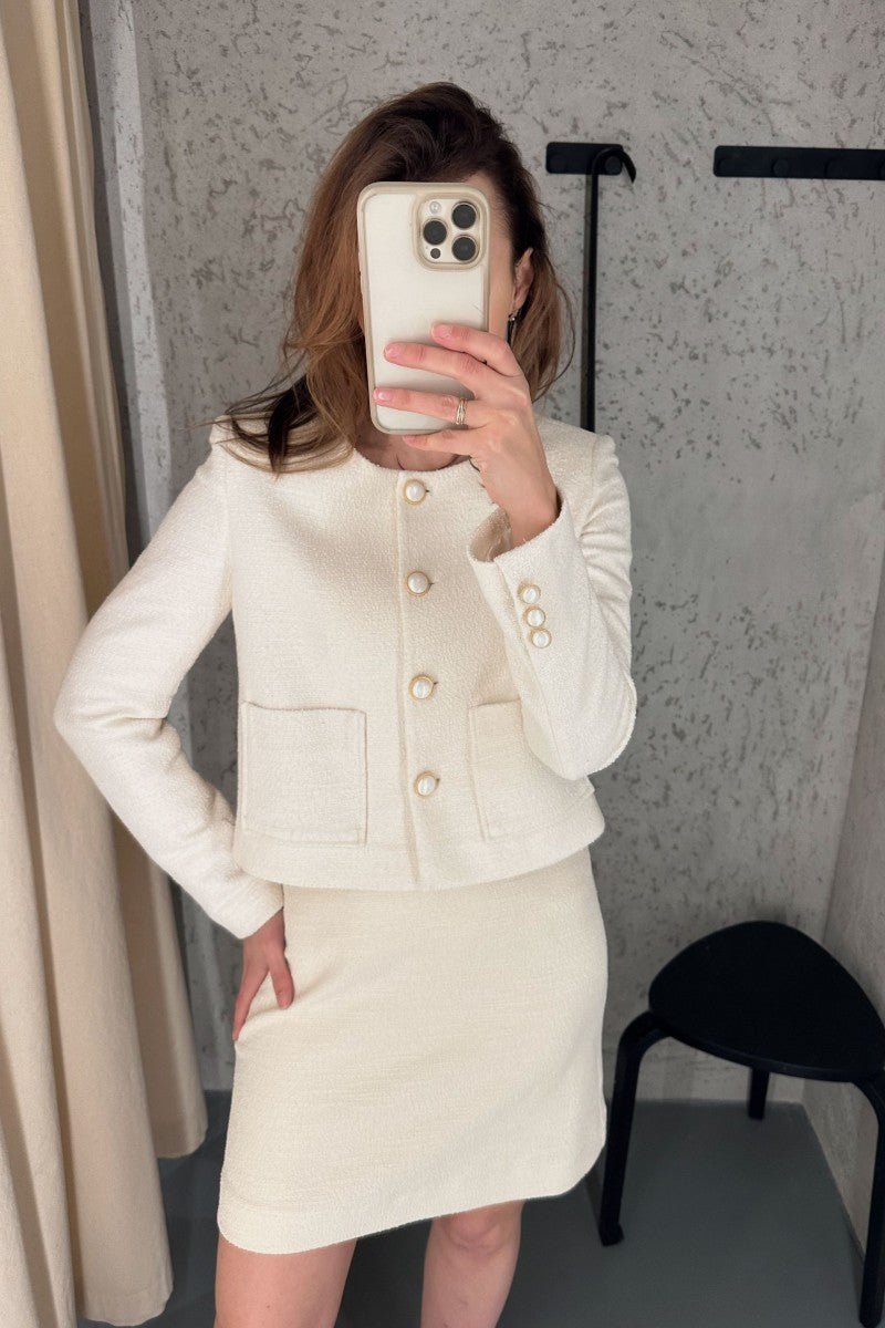 Cream bouclé skirt with a slightly trapezoidal shape