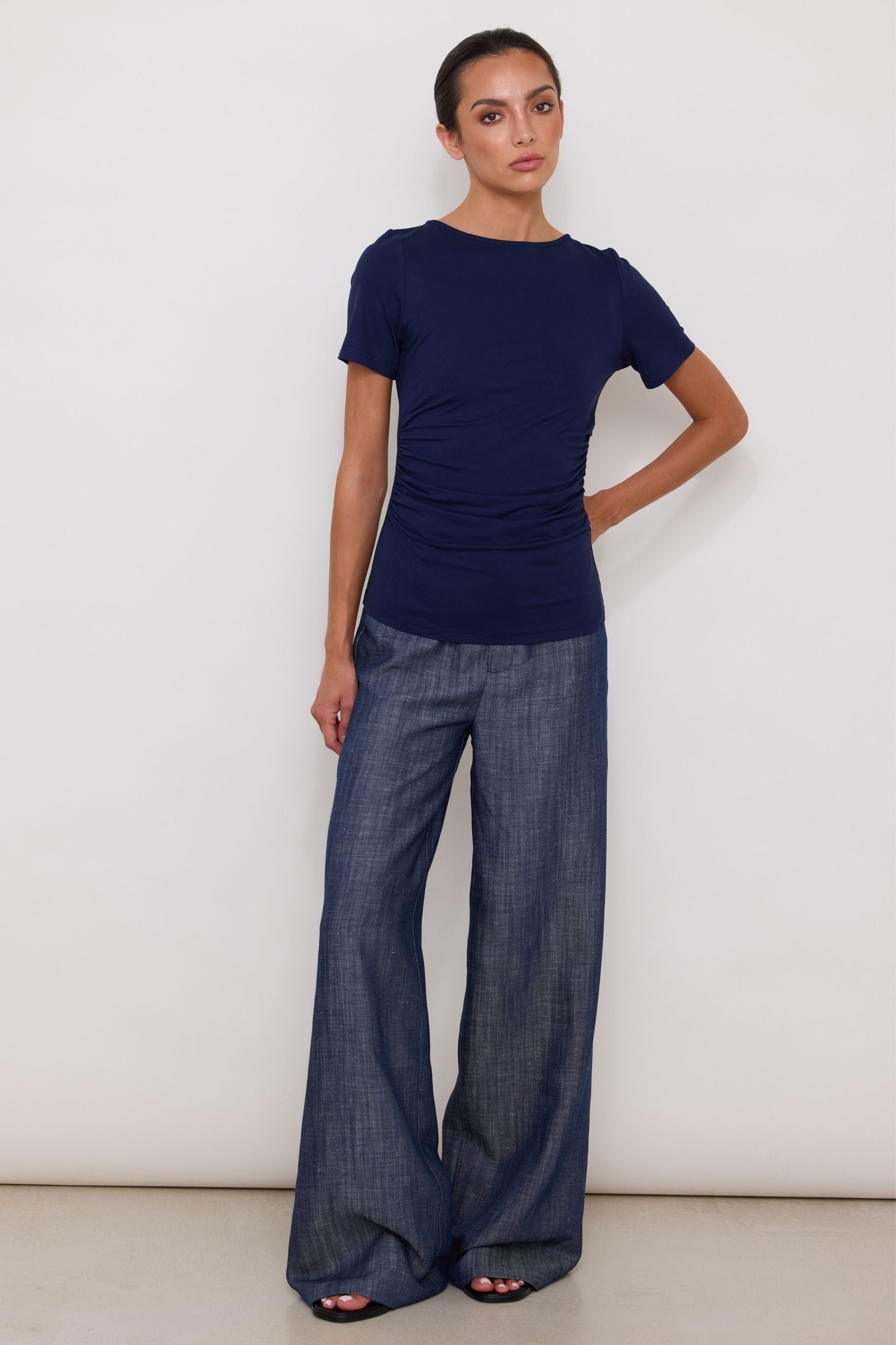 Navy blue short-sleeved blouse with draped sides