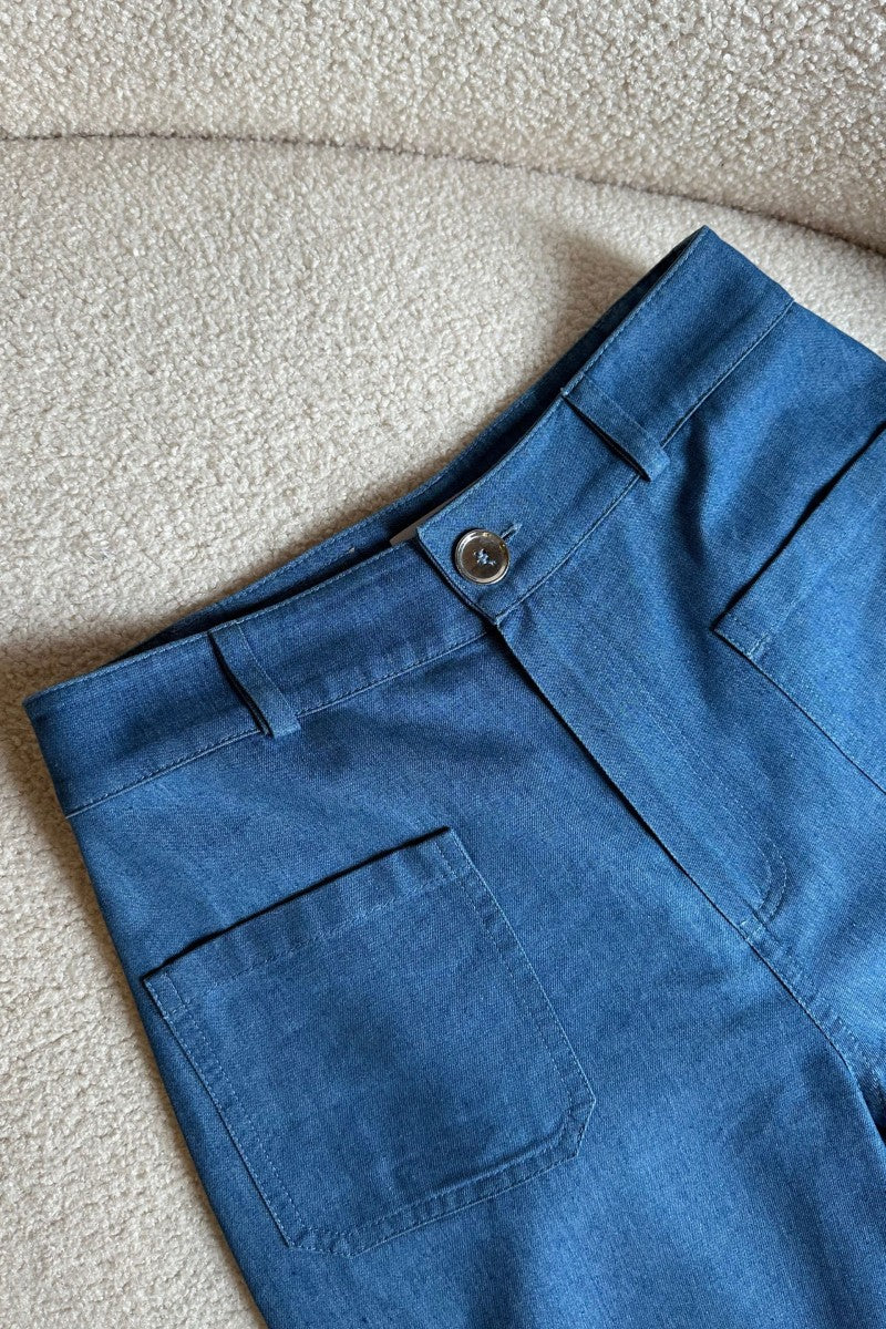 Navy blue denim trousers with patch pockets
